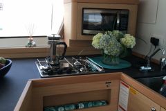 Galley With 3 Burner Stove, Oven, Microwave, Refrigerator and Freezer